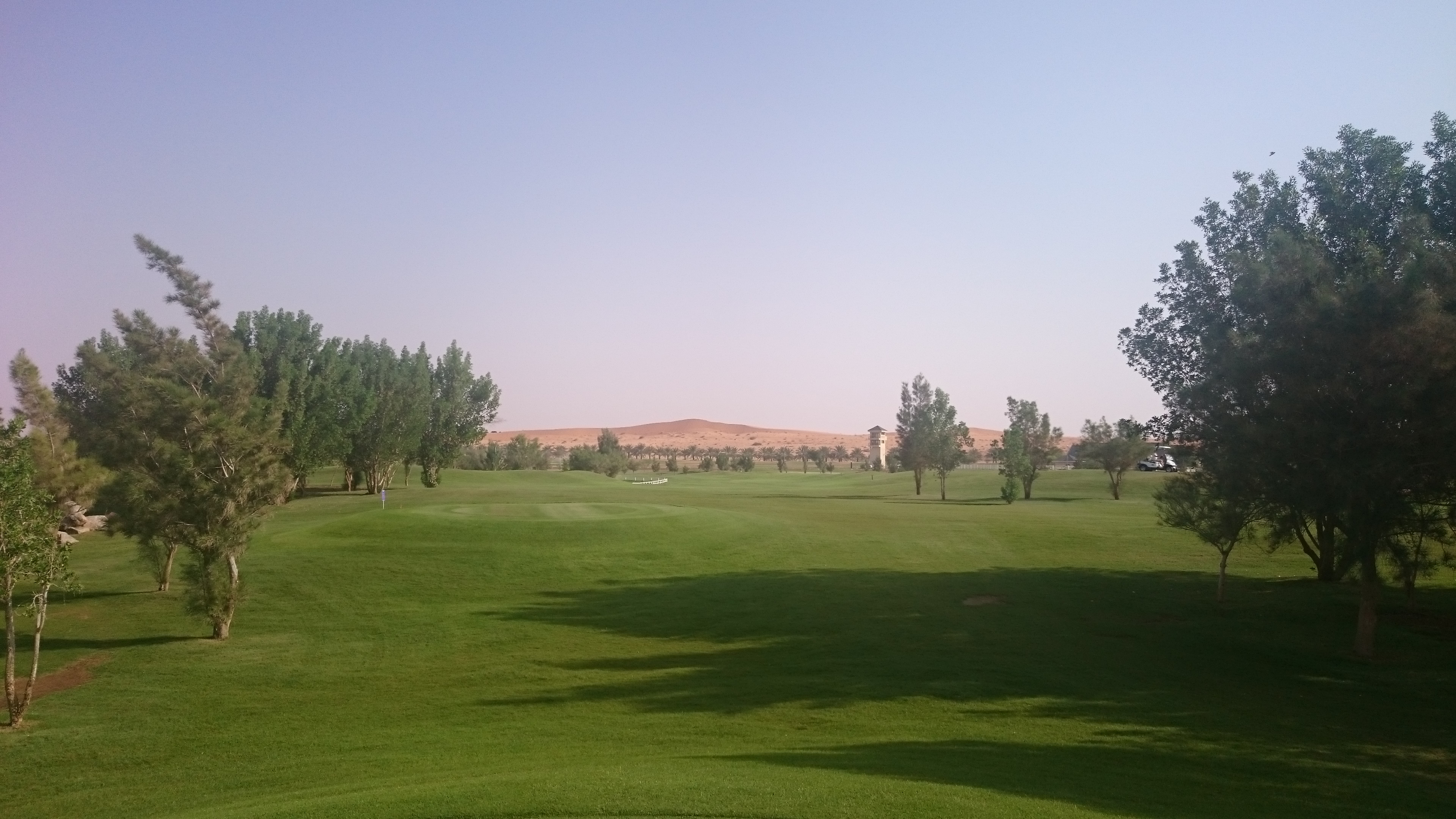 Well watered fairways contrast with the surrounding sand dunes at Nofa Golf Club