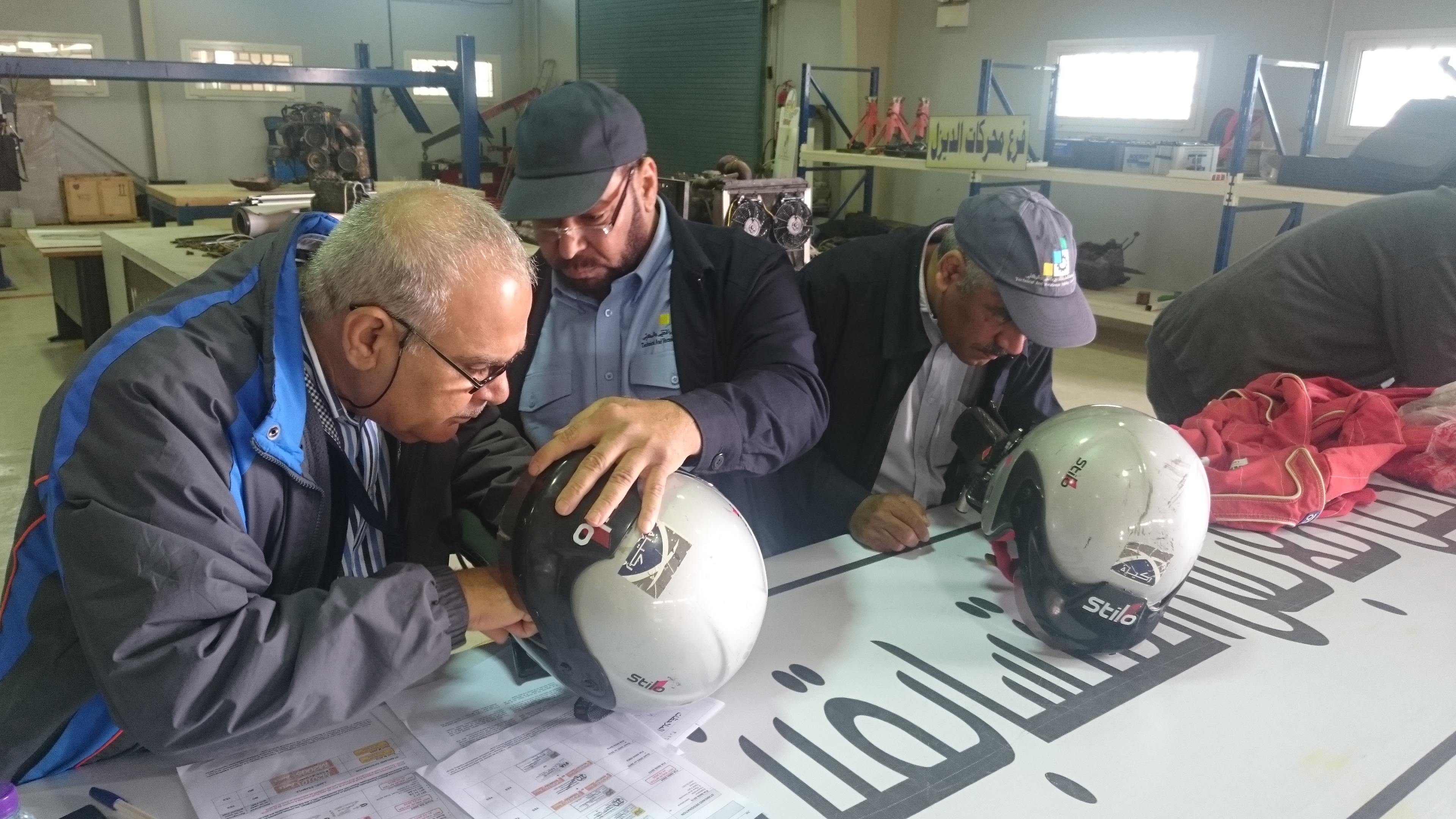 Checking helmet specifications at the Ha'il Rally