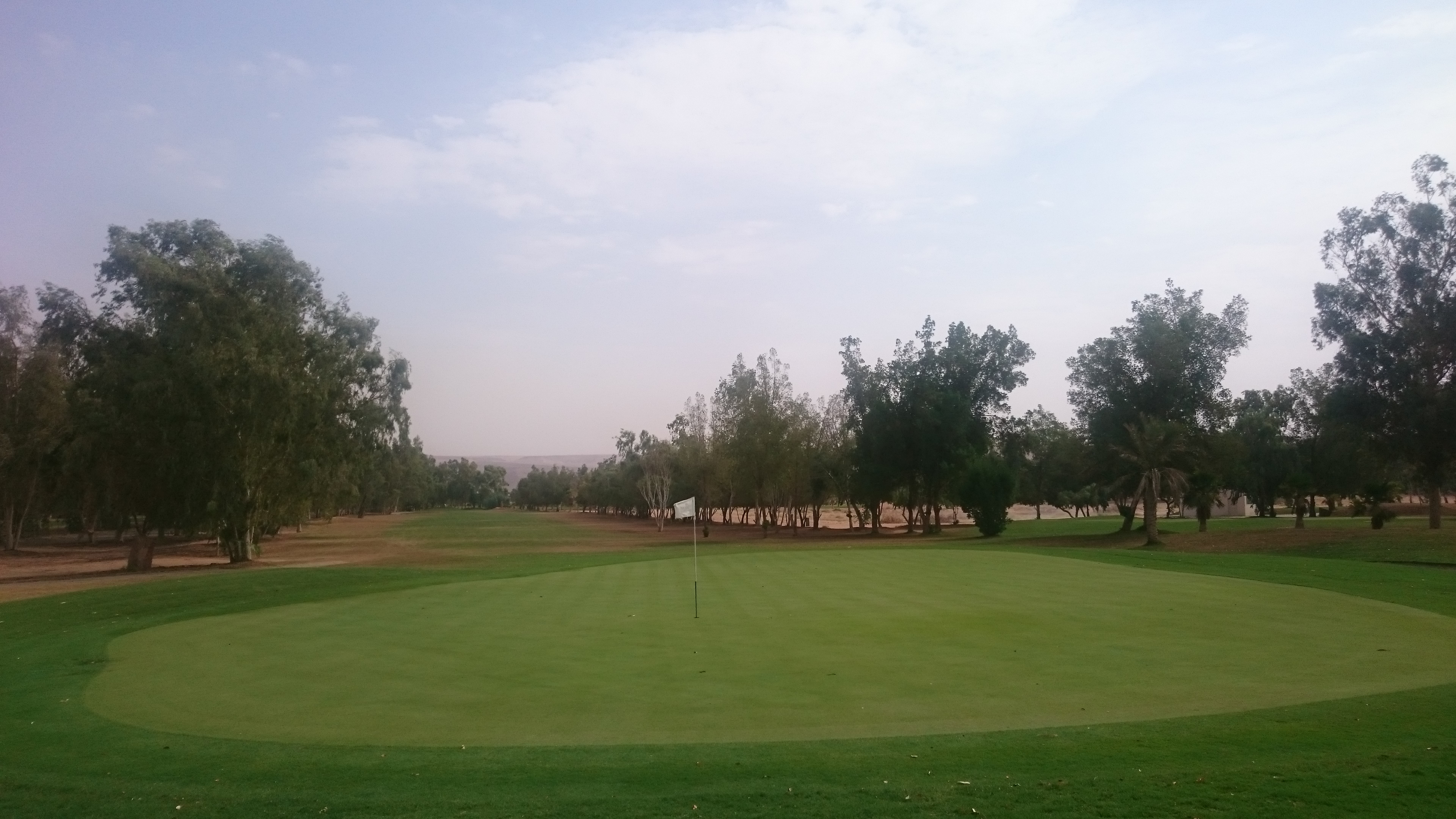 Trees on each side of the fairway at Dirab Golf Club